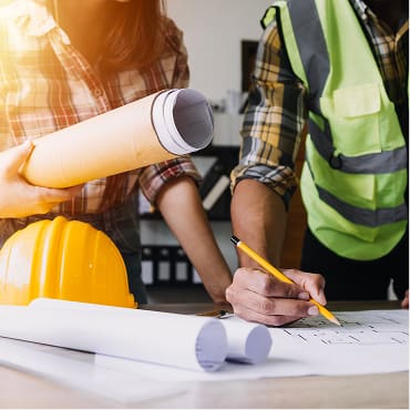 Professionals collaborating over architectural blueprints